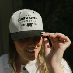Woman wearing The Creamery Stone Black Heritage Twill Hat