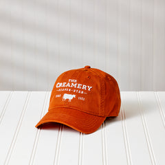 The Creamery Texas Orange Relaxed Twill Hat against white backdrop